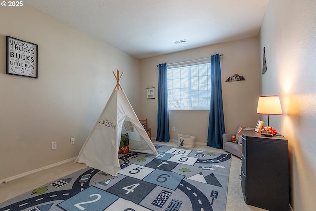 carpeted bedroom featuring visible vents and baseboards