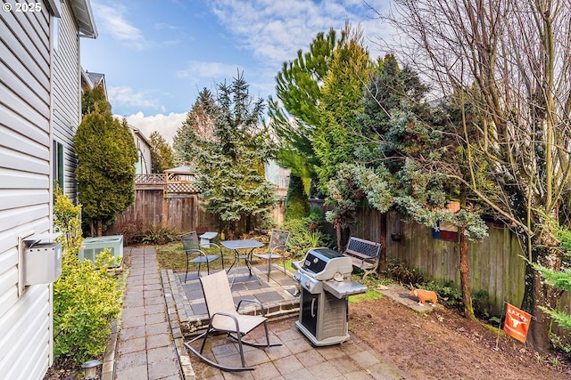 view of patio featuring a grill and a fenced backyard