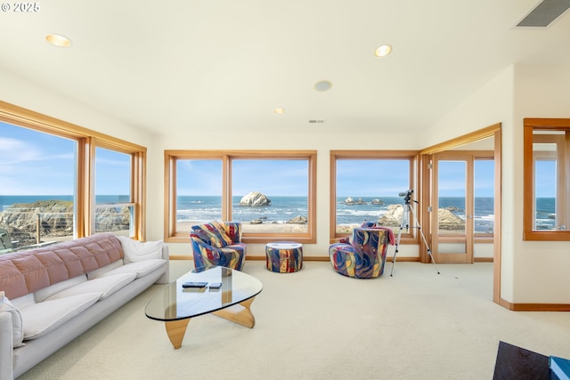 living room with a water view, recessed lighting, and visible vents
