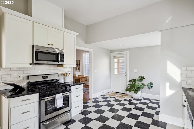5106 N Bowdoin St, Portland, OR 97203 - kitchen featuring stainless steel appliances, tile patterned floors, baseboards, and decorative backsplash