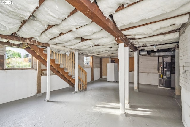 5106 N Bowdoin St, Portland, OR 97203 - basement with freestanding refrigerator, strapped water heater, healthy amount of natural light, and stairway