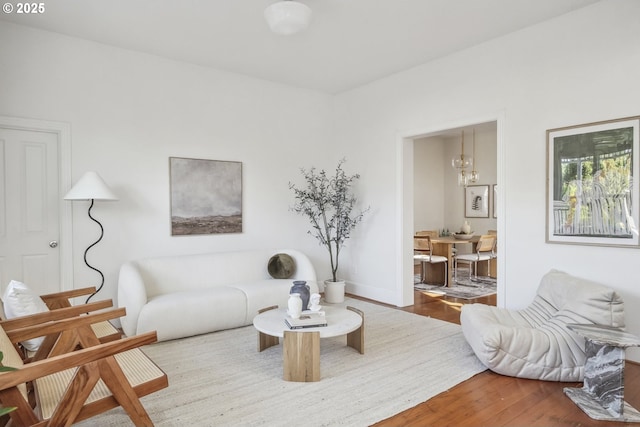 5106 N Bowdoin St, Portland, OR 97203 - living room with wood finished floors, a chandelier, and baseboards
