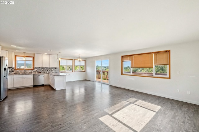 760 H St, Coos Bay, OR 97420 - unfurnished living room with healthy amount of natural light, a chandelier, a sink, and dark wood-style flooring