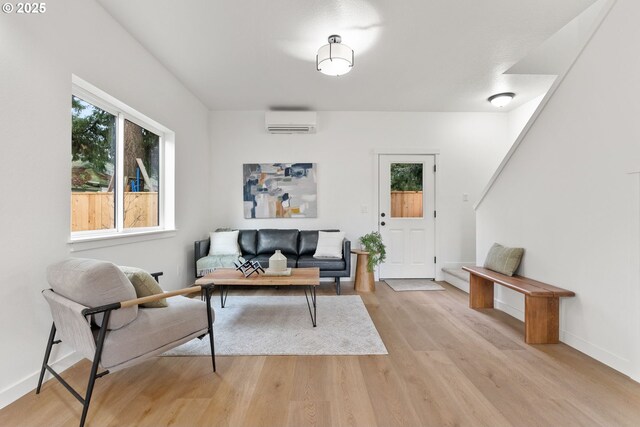 5712 SE Ramona St Unit C, Portland, OR 97206 - living room with a wall mounted air conditioner, light wood finished floors, and baseboards