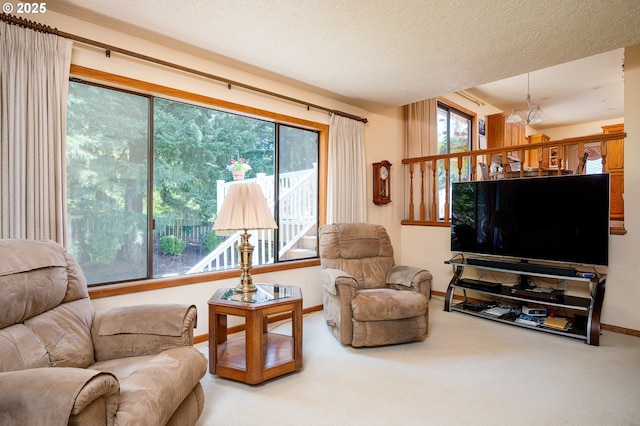 11560 SE 108th Ave, Happy Valley, OR 97086 - carpeted living room featuring baseboards and a chandelier
