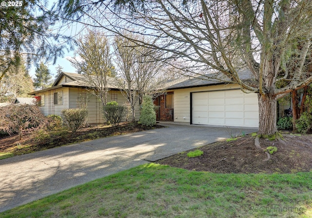 ranch-style house featuring an attached garage, brick siding, and driveway