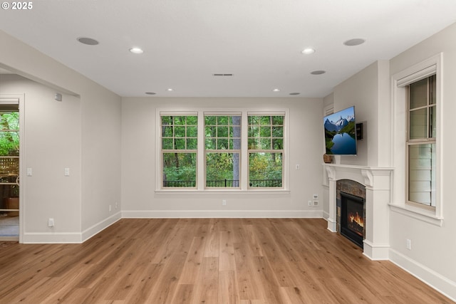4661 Trillium, Woods, Lake Oswego, OR 97035 - unfurnished living room featuring a glass covered fireplace, light wood-style floors, and recessed lighting
