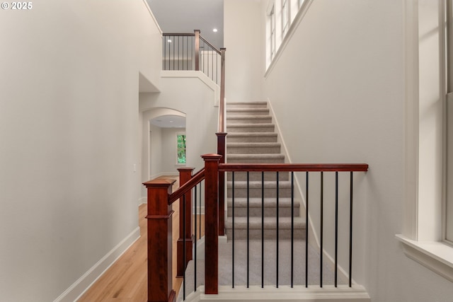 4661 Trillium, Woods, Lake Oswego, OR 97035 - staircase with wood finished floors, arched walkways, and a towering ceiling