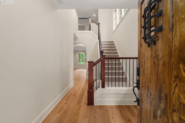 4661 Trillium, Woods, Lake Oswego, OR 97035 - stairway with wood finished floors, a high ceiling, and arched walkways