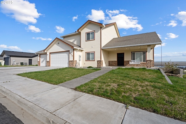 175 Truman Dr, Umatilla, OR 97882 - view of front facade featuring a front yard, an attached garage, stone siding, and driveway