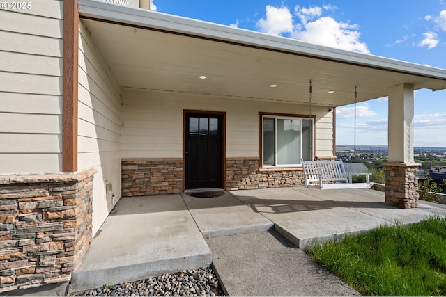 175 Truman Dr, Umatilla, OR 97882 - doorway to property with stone siding and covered porch