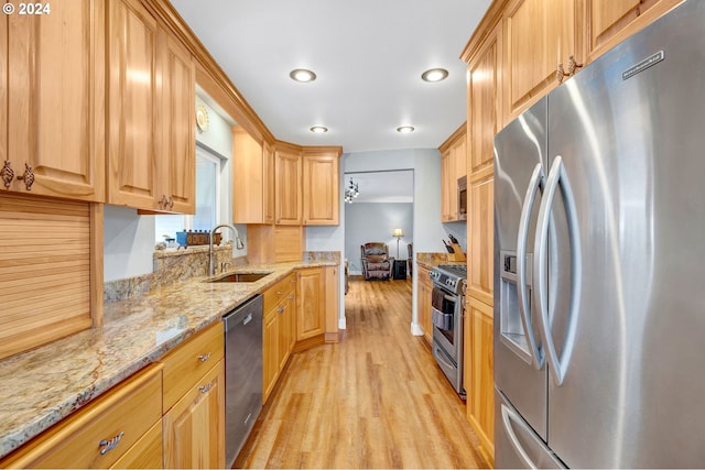 6836 NW Bony Rd, Yamhill, OR 97148 - kitchen featuring appliances with stainless steel finishes, a sink, light wood-type flooring, light stone counters, and recessed lighting