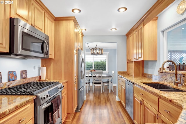 6836 NW Bony Rd, Yamhill, OR 97148 - kitchen featuring appliances with stainless steel finishes, a sink, a chandelier, light wood finished floors, and light stone countertops