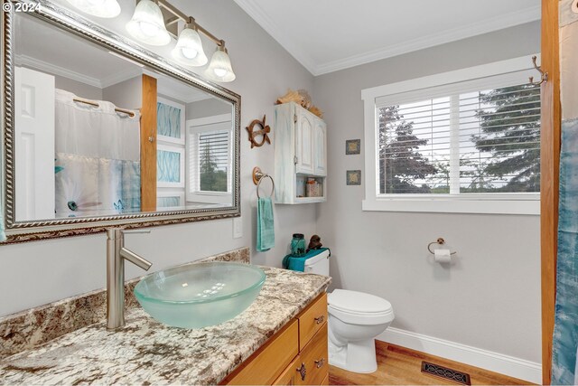 6836 NW Bony Rd, Yamhill, OR 97148 - bathroom with wood finished floors, crown molding, toilet, baseboards, and vanity
