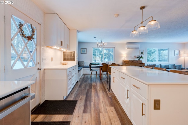 24492 SE Three Cedars St, Damascus, OR 97089 - kitchen featuring stainless steel dishwasher, open floor plan, dark wood-style floors, and healthy amount of natural light