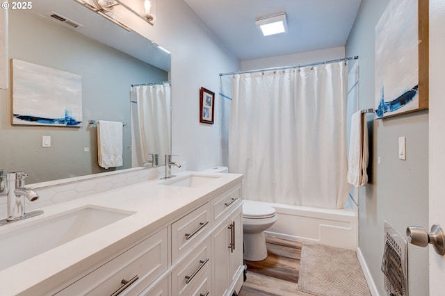 24492 SE Three Cedars St, Damascus, OR 97089 - bathroom featuring double vanity, wood finished floors, and shower / tub combo with curtain