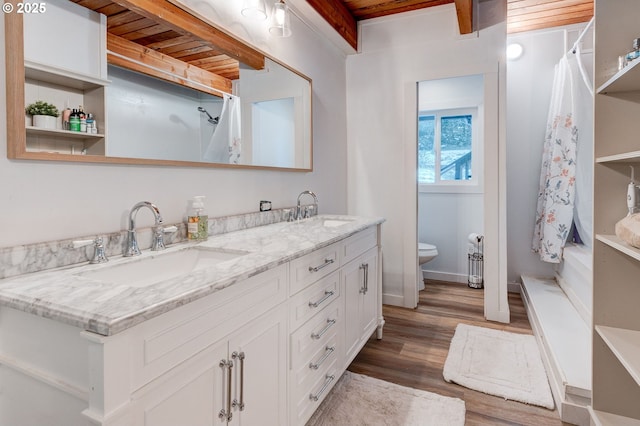 24492 SE Three Cedars St, Damascus, OR 97089 - bathroom featuring double vanity, wood finished floors, a shower with curtain, and a wood ceiling with exposed beams