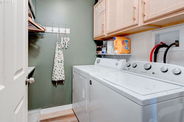 24492 SE Three Cedars St, Damascus, OR 97089 - laundry room with washer and dryer, cabinet space, and light wood-style flooring