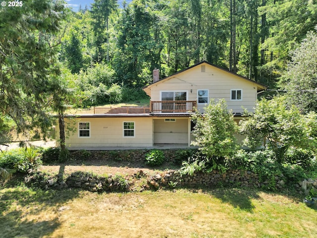 8157 S A St, Springfield, OR 97478 - rear view of property featuring a view of trees, a chimney, and a yard