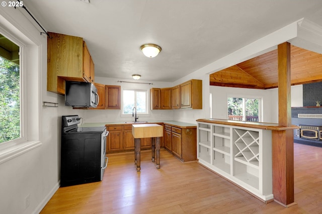 8157 S A St, Springfield, OR 97478 - kitchen featuring appliances with stainless steel finishes, brown cabinetry, light wood finished floors, light countertops, and wooden ceiling