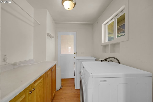 8157 S A St, Springfield, OR 97478 - laundry room featuring separate washer and dryer, light wood-type flooring, and cabinet space