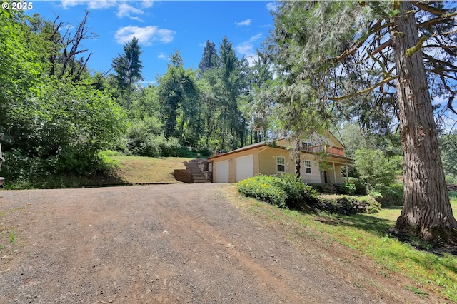8157 S A St, Springfield, OR 97478 - view of front of house featuring dirt driveway and a garage