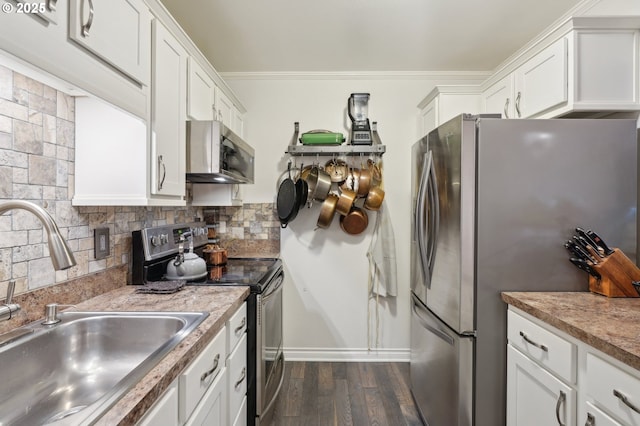 7548 SW Barnes Rd Unit G, Portland, OR 97225 - kitchen featuring appliances with stainless steel finishes, a sink, dark wood finished floors, white cabinetry, and ornamental molding