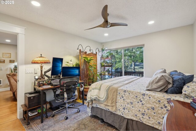 living room featuring ceiling fan, a brick fireplace, light wood-type flooring, and recessed lighting