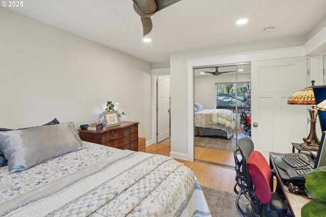 bedroom with ceiling fan, light hardwood / wood-style floors, and a closet