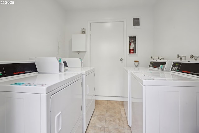 laundry room with light tile patterned floors and independent washer and dryer