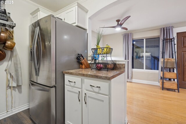 7548 SW Barnes Rd Unit G, Portland, OR 97225 - kitchen with freestanding refrigerator, light wood-style floors, white cabinets, a ceiling fan, and arched walkways