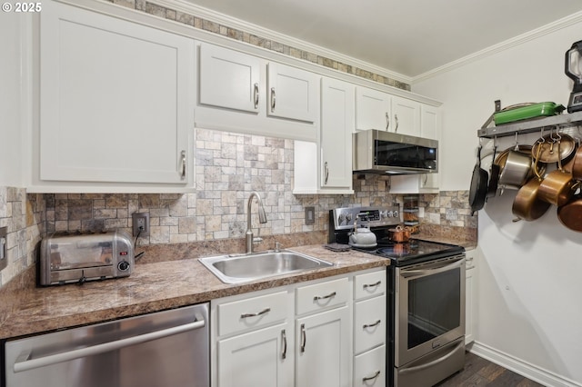 7548 SW Barnes Rd Unit G, Portland, OR 97225 - kitchen featuring stainless steel appliances, a sink, white cabinets, backsplash, and ornamental molding