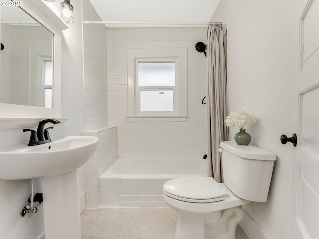 bathroom with shower / bathtub combination with curtain and toilet