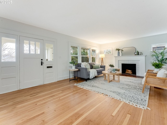 living room featuring wood-type flooring and a fireplace