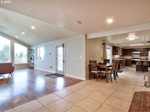 entryway with recessed lighting, baseboards, visible vents, and lofted ceiling