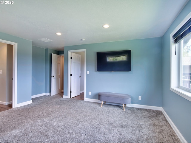 interior space with baseboards, recessed lighting, and carpet