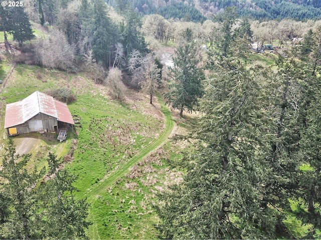 birds eye view of property featuring a view of trees