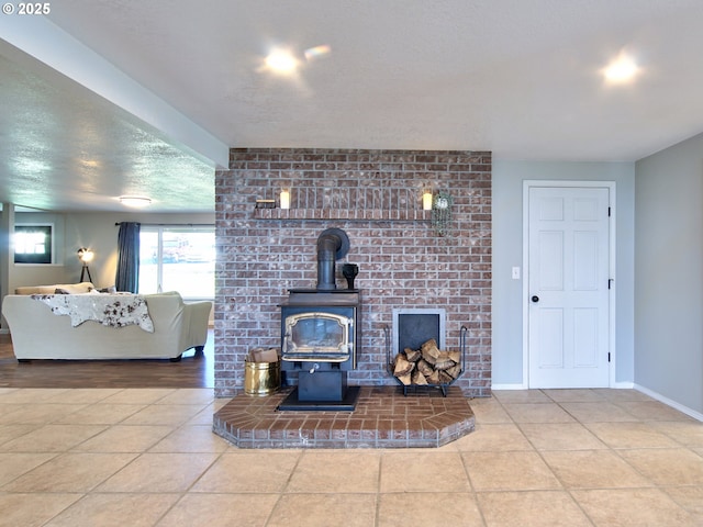 tiled living room with baseboards and a wood stove
