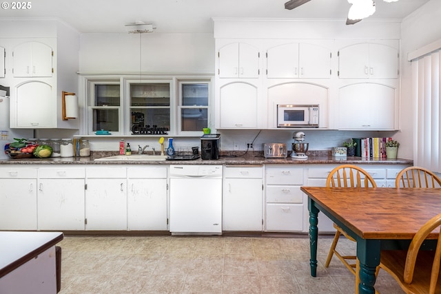 kitchen with sink, white appliances, ceiling fan, white cabinetry, and backsplash