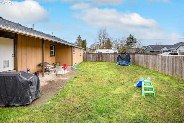 view of yard with a patio area and a trampoline