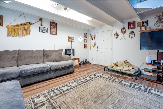 living room featuring hardwood / wood-style flooring and beamed ceiling