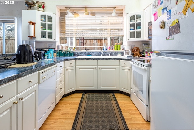 kitchen featuring light wood-type flooring, sink, white cabinets, and white appliances