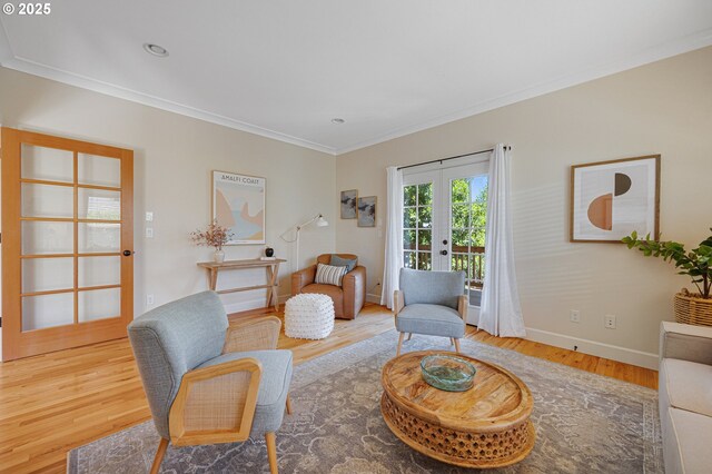 sitting room featuring french doors, wood finished floors, ornamental molding, and baseboards