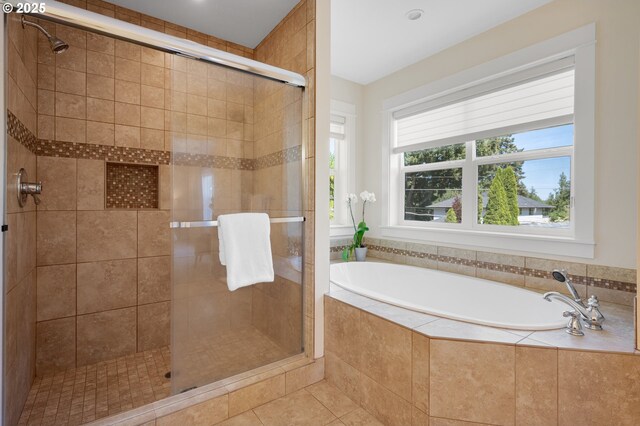 full bathroom featuring a garden tub, a stall shower, and tile patterned floors