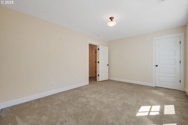unfurnished bedroom with carpet floors and baseboards