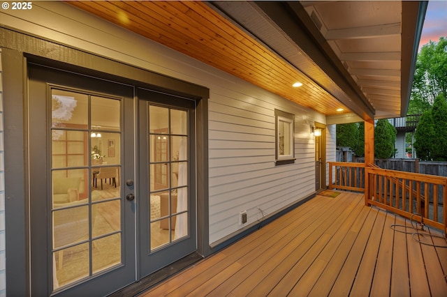 deck featuring french doors and fence