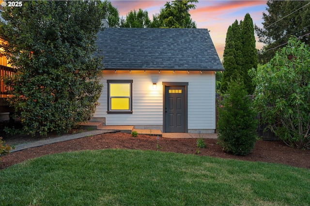 outdoor structure at dusk with a lawn