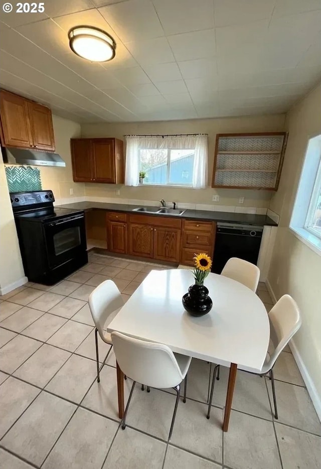 337 Clark St, Eugene, OR 97401 - kitchen with black appliances, under cabinet range hood, brown cabinetry, and light tile patterned flooring