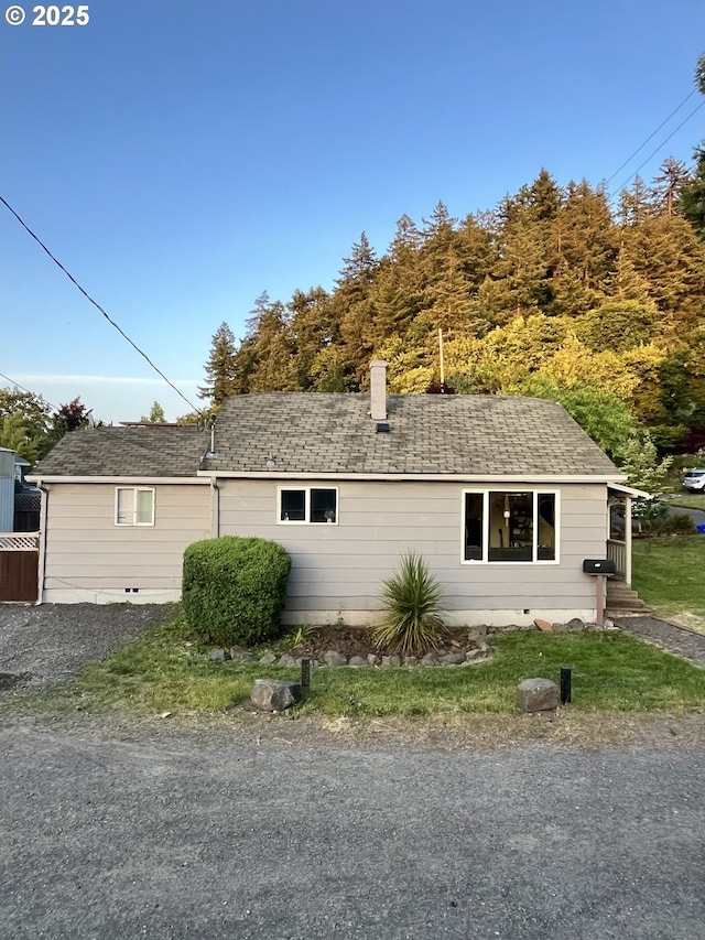 337 Clark St, Eugene, OR 97401 - view of side of property with a shingled roof and a chimney