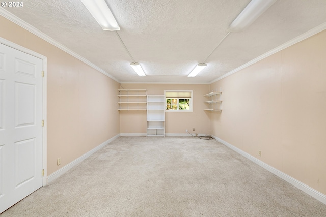 unfurnished room featuring a textured ceiling, carpet floors, and crown molding